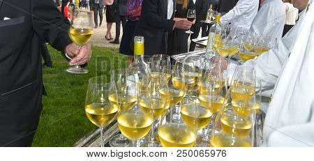 Professional Waiter In Uniform Is Serving Wine