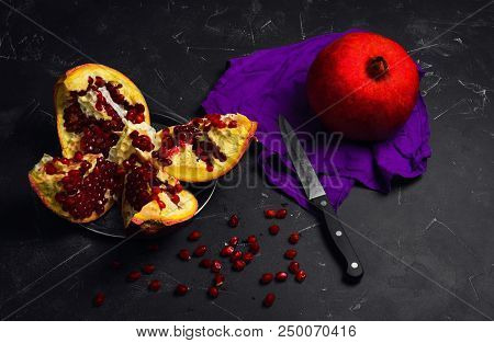 A Whole Ripe Red Pomegranate Garnet On A Napkin. Pieces Of A Cut Pomegranate Garnet, Seeds Garnet, K