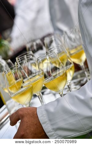 Professional Waiter In Uniform Is Serving Wine
