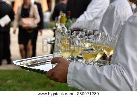 Professional Waiter In Uniform Is Serving Wine