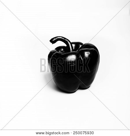 Black And Glossy Bell Pepper On A White Background