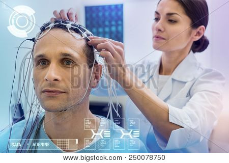 Connecting Wires. Attentive Experienced Doctor Carefully Helping Her Patient While Preparing Him For
