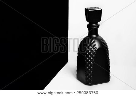 Black Unlabeled Glass Bottle On A White Background