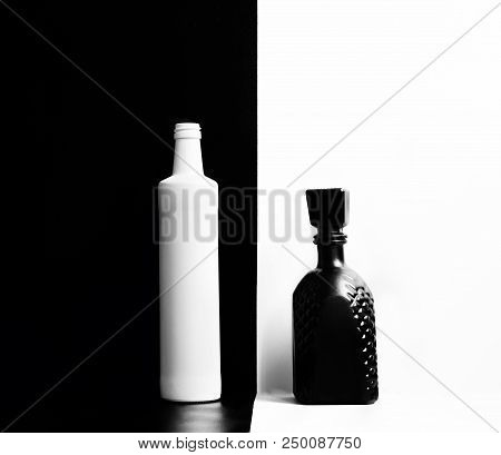 Black And White Unlabeled Glass Bottles On The Wall