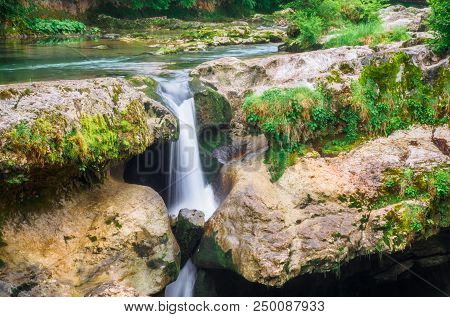 Amazing Forest Waterfall Flowing Into The Cold Mountain River With Large Stones. Martvili Canyon.