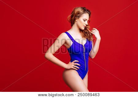 Pretty Bikini Model In Studio On Red Background