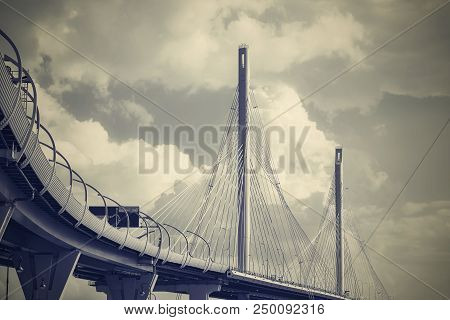 The Big And Modern Cable-stayed Bridge In St. Petersburg Against The Background Of The Cloudy Sky In