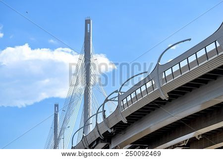 The Big And Modern Cable-stayed Bridge In St. Petersburg Against The Background Of The Cloudy Sky Cl