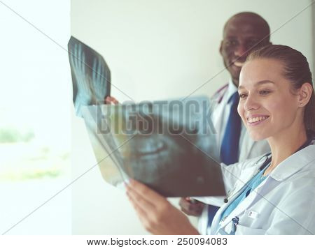 Doctors analyzing an x-ray in a meting. Doctors
