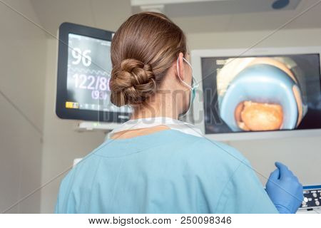 Doctor for internal medicine checking screen during examination in modern hospital 