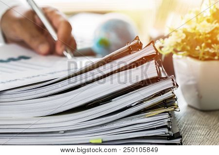 Businessman Hands Holding Pen For Working In Stacks Of Paper Files Searching Information Business Re