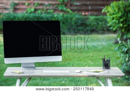 Selective Focus Of Smartphone, Digital Tablet And Computer With Blank Screen At Table Outdoors