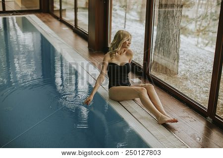 Pretty Young Woman Relaing By The Swimming Pool