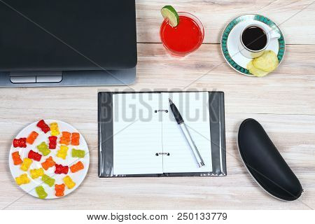 Designer Breakfast And Empty Notepad.  Cup Of Coffee, Juice, Gummy Bears,  Crispy Potato Chips, Glas