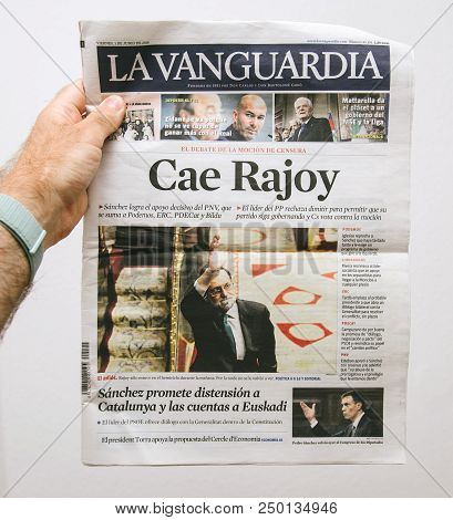 Barcelona, Spain - June 6 2018: Man Holding La Vanguardia Newspaper Cover With Cae Rajoy Translated 