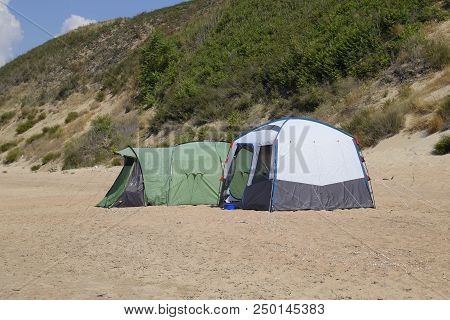 Tourist Tent On The Sand. Parking Of Tourists On The Sandy Beach.