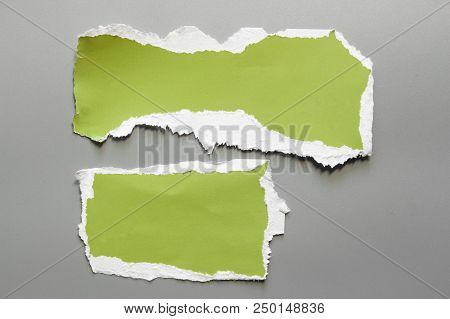 Green Corrugated Texture Paper Torn On Gray Background. Rip Of Cardboard Sheet Used As A Background 
