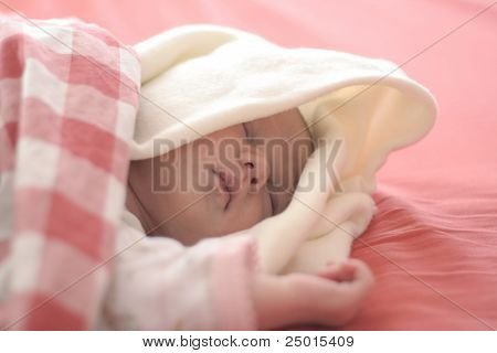 Baby sleeping in red