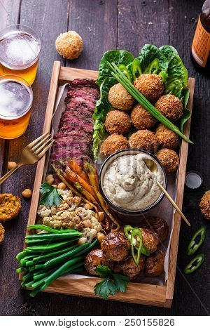Arabian Style Dinner: Falafel, Beef, Babaghanoush, Bean, Green Peas And Roots Vegs Top View