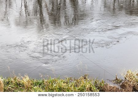 Dirty Water Near The River Bank In Autumn, Closep In Nature