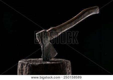 Close Up View Of Vintage Axe On Wooden Stump Isolated On Black