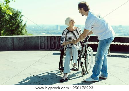 Stand Up. Attentive Woman Keeping Smile On Her Face And Putting Foot On The Ground While Going To St