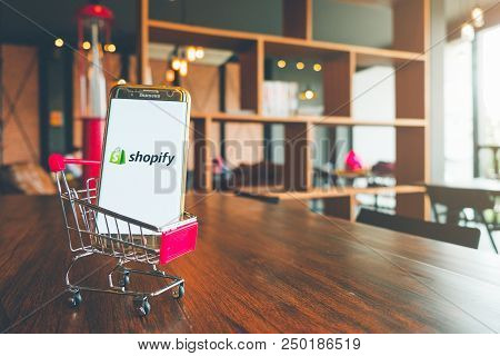 Chiang Mai,thailand - July 7,2018: Mobile Phone Using Shopify App On The Screen In Shopping Cart On 