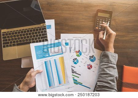 Real Estate Agent Working With Caculator,laptop And Document On Wooden Table In The Office, Loan And