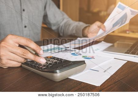 Real Estate Agent Working With Caculator,laptop And Document On Wooden Table In The Office, Loan And