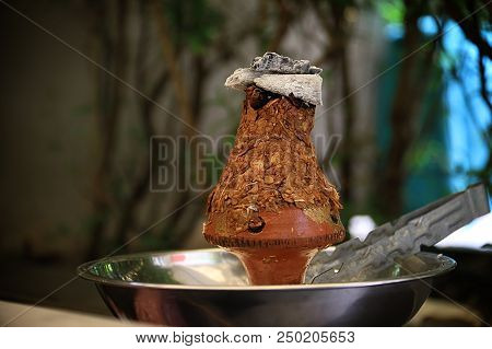 Ajami Tobacco Leaves Burning In A Hookah Head.