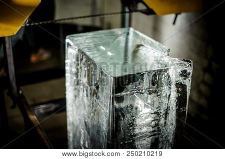 Unlighted Big Clear Ice Cube Standing On The Floor Under The Yellow Equipment Element On The Ice Pro