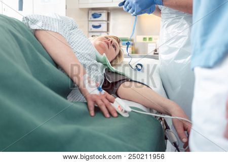 Nurses and doctor preparing patient for internal medicine examination