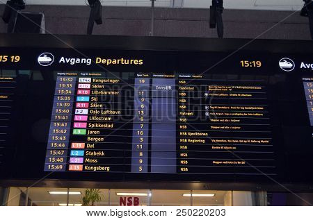 
Electronic display with the timetable of trains. Oslo central station. Oslo Central Station (Sentralstasjon) is main railway station in Oslo. June 17. 2018. Oslo,Norway