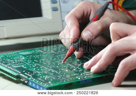 Tehnician Test Electronic Component With Oscilloscope In Laboratory