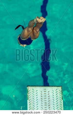 Female Diver Jumping Into The Pool