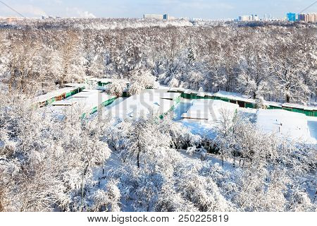 Aerial View Of Snow-covered Garages Between Urban Timiryazevsky Park And Apple Orchard In Koptevo Di