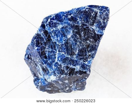 Macro Shooting Of Natural Rock Specimen - Rough Sodalite Gemstone On White Marble Background