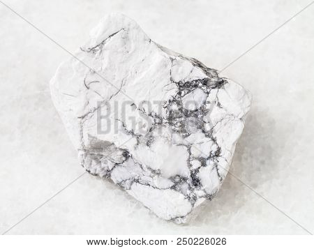 Macro Shooting Of Natural Rock Specimen - Raw Howlite Stone On White Marble Background