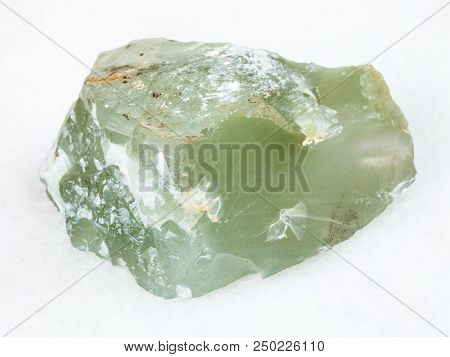 Macro Shooting Of Natural Mineral - Raw Prase (green Quartz) Stone On White Marble From Ural Mountai