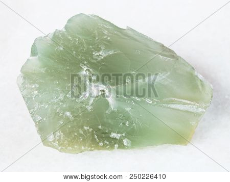 Macro Shooting Of Natural Mineral - Rough Prase (green Quartz) Stone On White Marble From Ural Mount