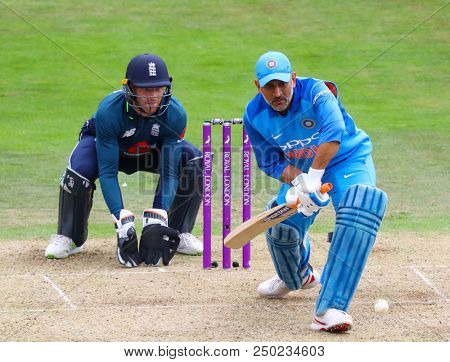 LEEDS, ENGLAND - JULY 17: MS Dhoni of  batting as wicketkeeper Jos Buttler looks on during the 3rd Royal London One day International match between England and India at Headingley Cricket Ground