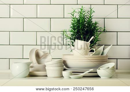 White Tableware For Serving. Dishes, Cups, Spoons, Utensils And Other Different White Stuff On Table