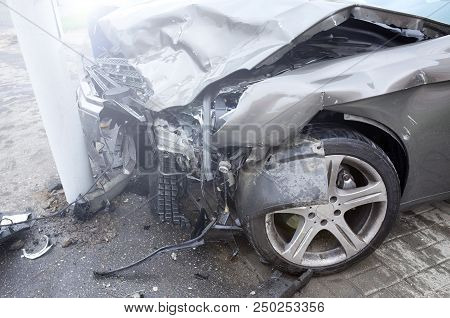 The Car Of A Drunk Driver Skidded And Thrown Out Of The Road Into A Traffic Light Post. A Road Accid