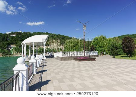 Quay With A Summer Stage On The Shore Of The Picturesque Lake Abrau In The Caucasus Mountains. Sunny