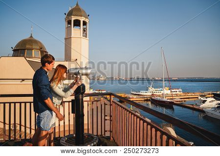 Odessa, Ukraine - August 06, 2015: Happy Romantic Attractive Young Couple Looking At Hi Spy Viewing 