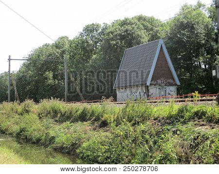 Small Railway Cottage Next To The Track On A Sunny Day