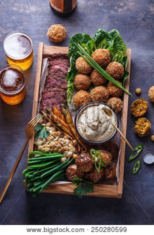 Pastrami, Falafel, Babagahanoush, Veggies And Beer In A Wooden Box, Copyspace
