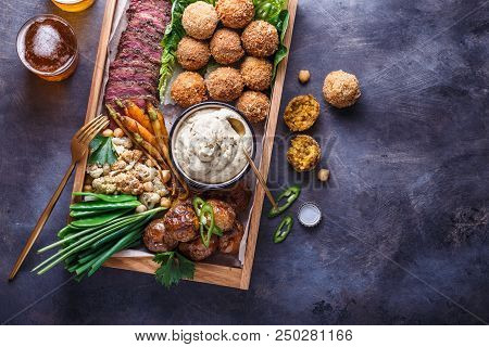 Close View Of Assorted Meze Appetizers Beef, Falafel, Babaghanoush, Potatoes In A Box, Copyspace