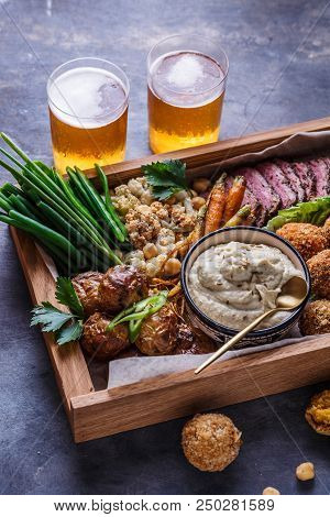 Pastrami, Falafel, Babagahanoush, Veggies And Beer In A Wooden Box, Copyspace