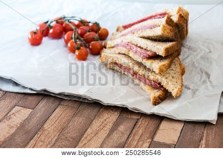 Wholemeal bread sandwich topped with Lyon rosette and butter